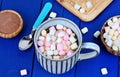 Hot chocolate with mini colorful marshmallows winter drink on table