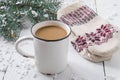 Hot chocolate in a mug and warm knitted mittens Royalty Free Stock Photo