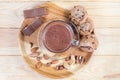 Hot chocolate, nuts and confections on wooden dish, top view Royalty Free Stock Photo