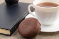 Hot chocolate, old book and chocolate biscuit Royalty Free Stock Photo