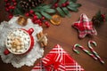 Hot chocolate surrounded by christmas items and tree Royalty Free Stock Photo