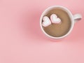 Hot chocolate with two heart shape marshmallows on pink background with copy space. Valentine`s day and beverage concept Royalty Free Stock Photo