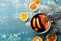 Hot christmas mulled wine or gluhwein with spices and orange slices on vintage teal table top view. Traditional drink on winter. Royalty Free Stock Photo