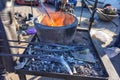 Hot coals in a brazier and metal forging tools. Royalty Free Stock Photo