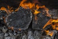 Hot coals and burning woods in the form of human heart. Glowing and flaming charcoal, bright red fire and ash. .Close-up