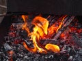 Hot coals, fire and flames close up photo. Burning charcoal for a barbecue Royalty Free Stock Photo