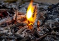 Hot coals and little flames in a dying fire Royalty Free Stock Photo