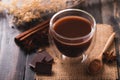 Hot cocoa in cup glass with chocolate, cinnamon stick, star anise and cocoa powder Royalty Free Stock Photo