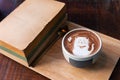 Hot cocoa cup topping cat shape with old books Royalty Free Stock Photo
