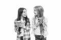 Hot cocoa recipe. Make sure kids drink enough water. Girls kids hold cups white background. Sisters hold mugs. Drinking