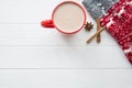 Hot cocoa with spices:cinnamon and anise stars and christmas ornament socks on white wooden background. Top view, copy space for Royalty Free Stock Photo