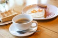 Hot coffee and American breakfast with sunny side up eggs, bacon, toast Royalty Free Stock Photo