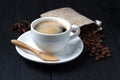 Hot coffee with anise, a wooden spoon and a bag of coffee beans Royalty Free Stock Photo
