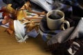 Hot coffee, Autumn leaves, crayons, feather, and a drawing on wood background