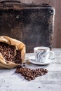 Hot coffee with coffee beans spilled out of the bag Royalty Free Stock Photo