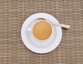 Hot Coffee cream in white cup with tea spoon on wooden table. Royalty Free Stock Photo