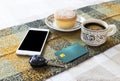 Hot coffee in cup, bakery, credit card, mobile phone and car key Royalty Free Stock Photo