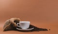 Hot coffee cup and coffee beans in burlap bag Royalty Free Stock Photo