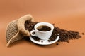 Hot coffee cup and coffee beans in burlap bag Royalty Free Stock Photo