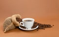 Hot coffee cup and coffee beans in burlap bag Royalty Free Stock Photo
