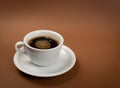 Hot coffee cup on brown background close up