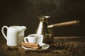 hot coffee cup with cinnamon sticks with a creamer and old pot/hot coffee cup with cinnamon sticks with a creamer and old pot. se Royalty Free Stock Photo