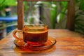 Hot coffee cup on glass cup with smoke on wooden chair table background. Top view Royalty Free Stock Photo