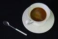 Hot coffee cup in the saucer with small silver spoon Royalty Free Stock Photo