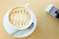 Hot of coffee drink on wooden table bar with mobile phone Royalty Free Stock Photo