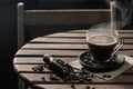 Hot coffee in a glass cup and  coffee beans on wooden table on dark background Royalty Free Stock Photo