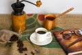 Hot coffee, glasses, fountain pen, book and coffee beans on a Coffee Gunny Sack Royalty Free Stock Photo