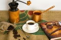 Hot coffee, glasses, fountain pen, book and coffee beans on a Coffee Gunny Sack Royalty Free Stock Photo