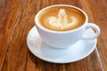 Hot coffee latte cappuccino cup with beautiful `rosetta` latte a