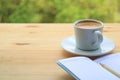 Hot Coffee with Lined Note Papers on the Wooden Table of Outdoor Seating Royalty Free Stock Photo