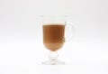 Hot coffee with milk in a transparent glass cup on a white background Royalty Free Stock Photo