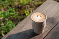 Hot coffee in the morning on wood table with blurred garden in b