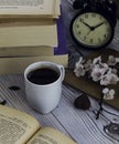 Hot coffee with old books and alarm clock Royalty Free Stock Photo