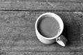 Hot coffee on old wooden plank in low key black and white style Royalty Free Stock Photo