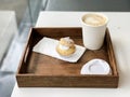 Hot coffee in paper cup and Choux Cream