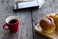 Hot coffee red cup and buns for life style technology concept Royalty Free Stock Photo