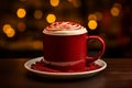 Hot coffee with red velvet cookie decoration in a red mug on a blur background