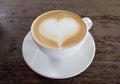 Hot coffee on table with heart shape on top of white cup Royalty Free Stock Photo