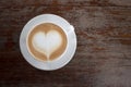 Hot coffee on table with heart shape on top of white cup from top view. Copy space Royalty Free Stock Photo