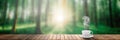 A hot coffee on the table on a spring forest background Royalty Free Stock Photo