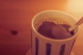 Hot coffee with a teaspoon in Japanese cup on bamboo coaster. Royalty Free Stock Photo