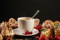 Hot coffee and a variety of berry french eclairs Royalty Free Stock Photo