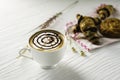 Hot coffee in white cup, with bakery and coffee beans in hemp bag, placed on white wood table, With sunshine in morning,Beauty Royalty Free Stock Photo