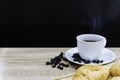 Hot coffee in white cup with coffee bean and croissants on wooden table Royalty Free Stock Photo