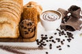 Hot coffee in white cup and beautifully decorated milk bubbles,bakery  placed on white wood table,With sunshine in morning,beauty Royalty Free Stock Photo