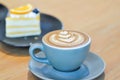 hot cofffee, cappuccino coffee or latte coffee or flat white and orange cake with orange and blueberry topping